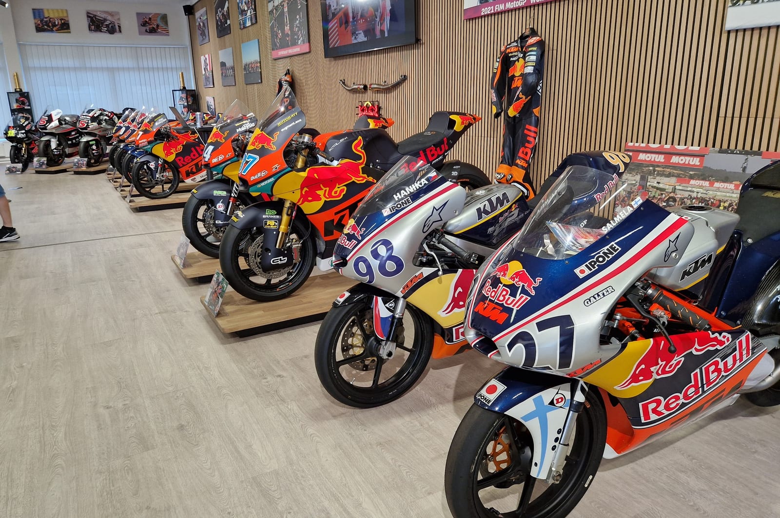A long row of thoroughbred road racing bikes from over the years.